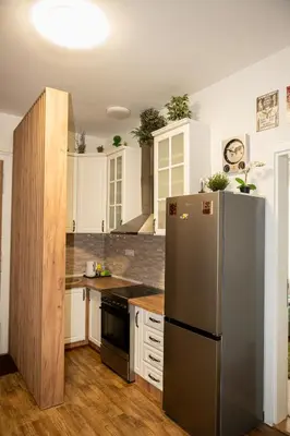 a kitchen with a stainless steel refrigerator and white cabinets at Botanical9, Belgrade centre, 2 bedroom apartment with Netflix in Belgrade
