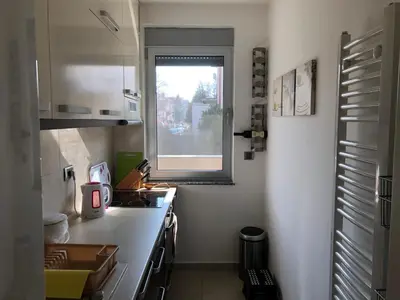 a small kitchen with a sink and a window at Modern 1 Bed Apartment, near shopping mall Stadion in Belgrade