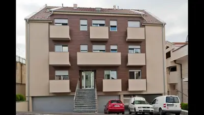 a building with two cars parked in front of it at Modern 1 Bed Apartment, near shopping mall Stadion in Belgrade