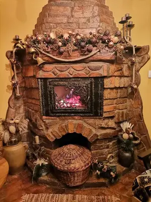 a stone fireplace with a fire place at Etno kuća Teodora in Staji°evo