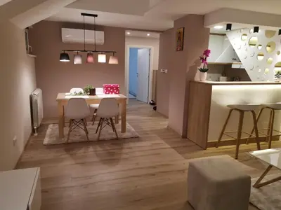 a kitchen and living room with a table and chairs at Apartments LaVu in Belgrade
