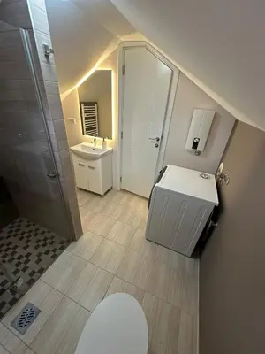 a bathroom with a white sink and a shower at Apartments LaVu in Belgrade