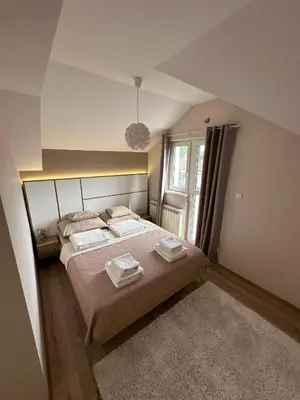 a bedroom with a bed with two towels on it at Apartments LaVu in Belgrade