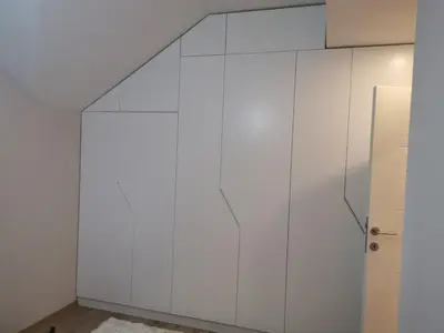 a white room with a wall of white cabinets at Apartments LaVu in Belgrade