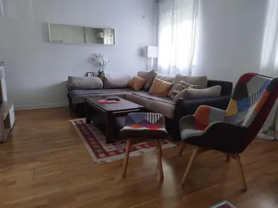 a living room with a couch and two chairs at Apartman Natasa in Karaburma