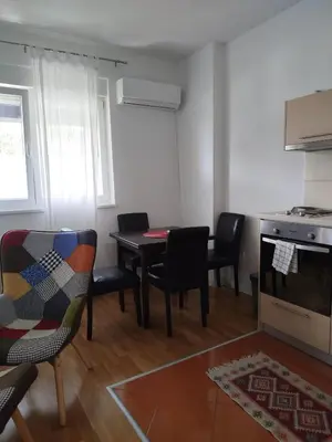 a kitchen and dining room with a table and chairs at Apartman Natasa in Karaburma