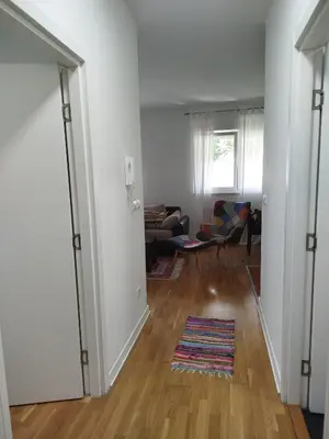 an open hallway with a living room with a couch at Apartman Natasa in Karaburma