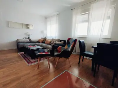 a living room with a couch and a table at Apartman Natasa in Karaburma