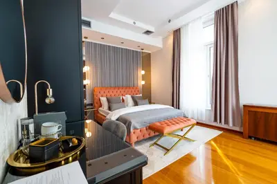 a bedroom with a bed and a desk in a room at NATALI Luxury suites PARKING in Belgrade