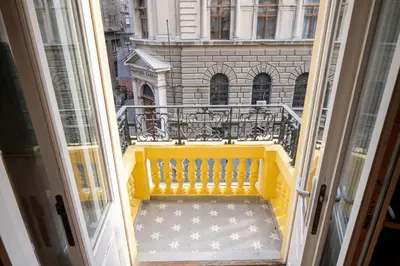 an open door to a balcony with a yellow bench at NATALI Luxury suites PARKING in Belgrade