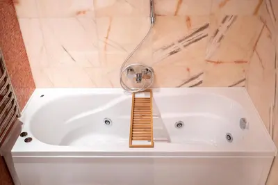a white bath tub with a ladder in a bathroom at NATALI Luxury suites PARKING in Belgrade