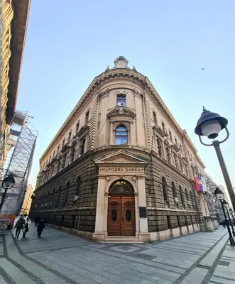 a large building with a wooden door on a street at NATALI Luxury suites PARKING in Belgrade