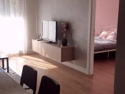 a living room with a television and a bed at Apartment Mona in Belgrade