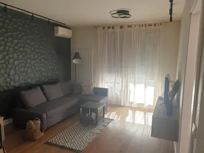 a living room with a couch and a table at Apartment Mona in Belgrade