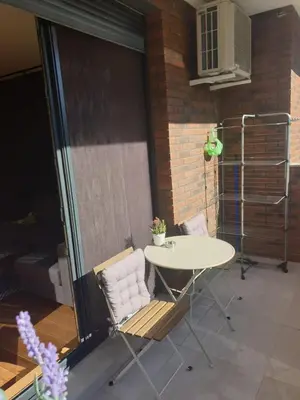 a patio with a table and chairs in a room at Apartment Mona in Belgrade