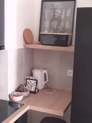 a kitchen counter with a coffee maker on a shelf at Apartment Mona in Belgrade