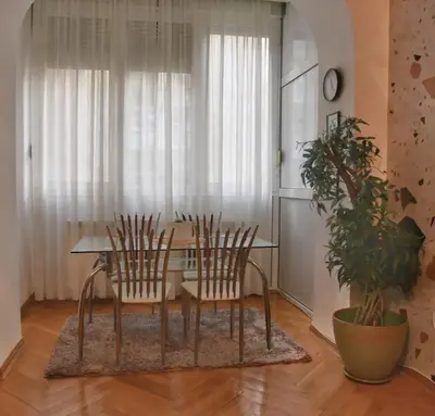 a dining room with a table and two chairs at Apartment Carpe diem in Belgrade in Belgrade