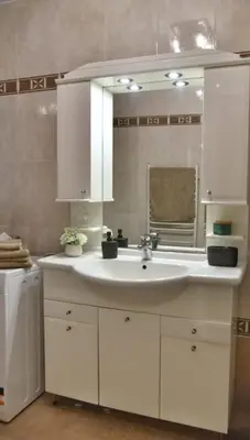 a bathroom with a white sink and a mirror at Apartment Carpe diem in Belgrade in Belgrade