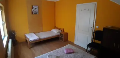 a small room with a bed and a door at Rosso Apartments 2 in Belgrade