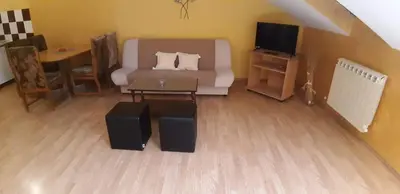a living room with a couch and a tv and a table at Rosso Apartments 2 in Belgrade