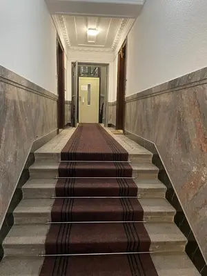 an empty hallway with stairs leading to a door at Royal MegaKing apartment in Belgrade