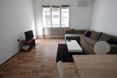 a living room with a couch and a tv at Royal MegaKing apartment in Belgrade