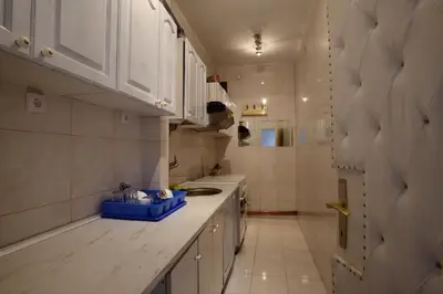 a kitchen with white cabinets and a blue bowl on the counter at Royal MegaKing apartment in Belgrade
