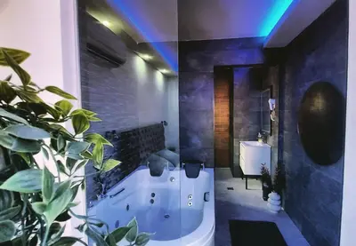 two pictures of a bathroom with a tub and a sink at Stars lux room in Belgrade