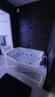 a white bath tub in a bathroom with a window at Stars lux room in Belgrade