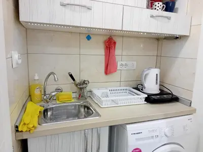 a kitchen counter with a sink and a washing machine at Iv Skadarlija in Belgrade