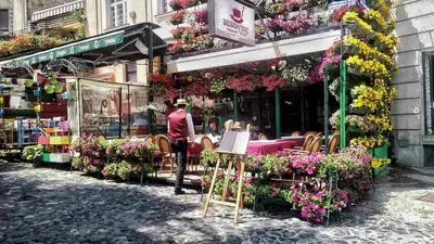 a man standing in front of a flower shop at Iv Skadarlija in Belgrade