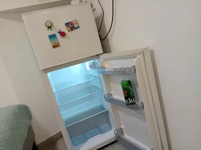 an empty refrigerator with its door open in a room at Iv Skadarlija in Belgrade