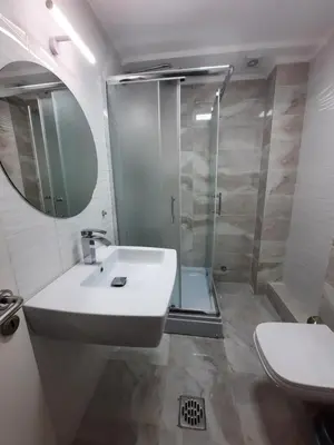 a bathroom with a white sink and a shower at Apartman 57 in Vračar (historical)