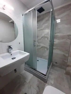 a bathroom with a glass shower and a sink at Apartman 57 in Vračar (historical)