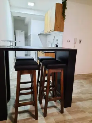 a kitchen with a black counter and stools at Apartman 57 in Vračar (historical)