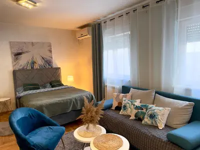 a living room with a couch and a bed at Belgrade Apartment 1 in Zvezdara