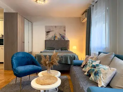 a living room with a couch and a bed at Belgrade Apartment 1 in Zvezdara