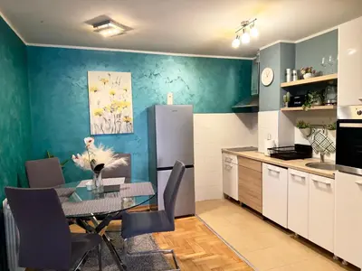 a kitchen and dining room with a table and chairs at Belgrade Apartment 1 in Zvezdara