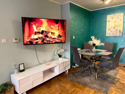 a living room with a fireplace on the wall at Belgrade Apartment 1 in Zvezdara