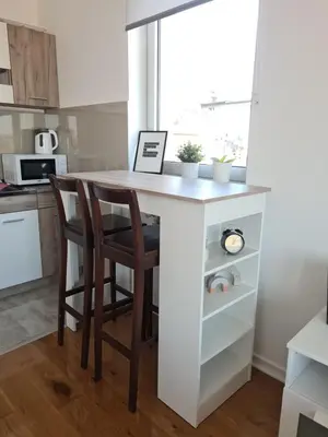 a kitchen with a table with two chairs and a window at Jordan Apartment - City Center in Belgrade