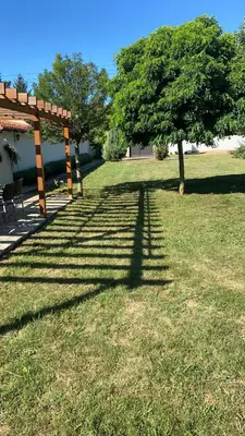 a shadow of a gazebo and a tree in a yard at Vikendica Lešić in Čortanovci