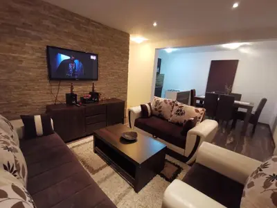 a living room with a couch and a tv at Vikendica Lešić in Čortanovci