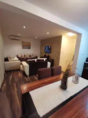 a living room with a couch and a table at Vikendica Lešić in Čortanovci