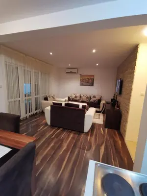 a living room with a couch and a table at Vikendica Lešić in Čortanovci
