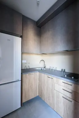 a kitchen with wooden cabinets and a white refrigerator at Belly in Vračar (historical)