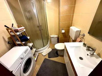 a bathroom with a washing machine and a sink at Belgrade Apartment 2 in Zvezdara