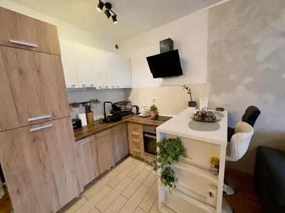 a kitchen with white cabinets and a white counter at Belgrade Apartment 2 in Zvezdara