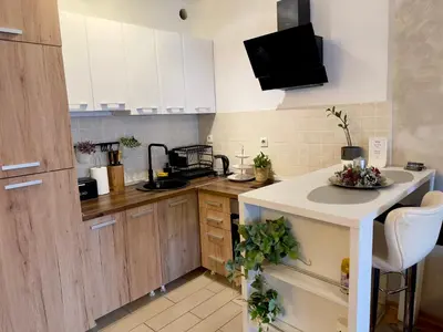 a kitchen with white cabinets and a counter top at Belgrade Apartment 2 in Zvezdara