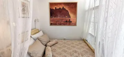 a bedroom with a bed and a painting on the wall at Gala City Center Apartman in Belgrade