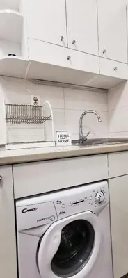 a washing machine in a kitchen with a sink at Gala City Center Apartman in Belgrade